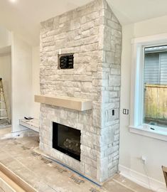 a room with a brick fireplace in it