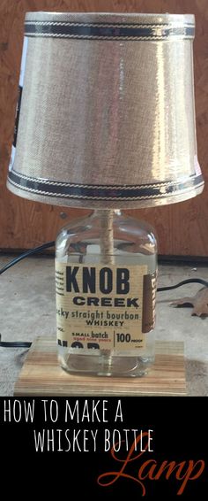 a lamp that is sitting on top of a wooden block with the words how to make a whiskey bottle lamp