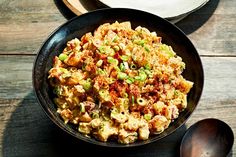 a bowl filled with food sitting on top of a wooden table