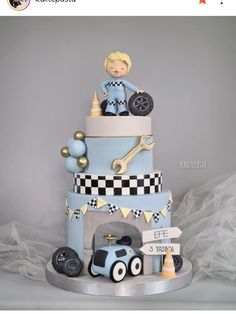 a three tiered cake with a boy on top