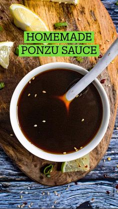 homemade ponju sauce in a white bowl on a wooden cutting board with lemon slices