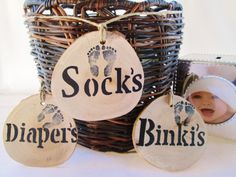 a basket with some baby's footprints on it and two tags hanging from the handles