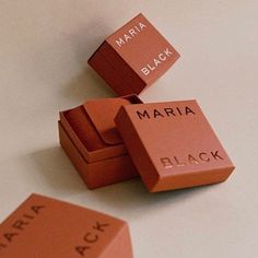 three different types of black and orange blocks on a table with the words maria black written on them