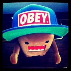 an odd looking hat with the word obey on it