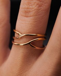 This is a smaller version of our popular Curved Wraparound ring! This ring makes a delicate and minimalist cocktail ring and is also great for everyday wear. This listing is for ONE SINGLE ring in SOLID 14K GOLD. Made from THICK (1.5mm) metal wire.Available in a SMOOTH or HAMMERED finish. This ring is unique and is sure to turn some heads! To make this style, we wrap a length of wire and then securely solder it at two points. Because the metal is not wrapped over itself, like the original Wraparound Ring style, it lays more flat on the finger. In the final stages, the ring is then left in its smooth finish or we lightly hammer the ring for a bright, reflective shine. It is your choice at checkout! SIZING NOTE: Because this style is wider than a classic Stacking Ring, we recommend sizing up Gold Rings Aesthetic, Gold Wire Ring, Interlocking Ring, Bold Rings, Flat Back Earrings, Symbolic Jewelry, Travel Jewelry Case, Solid Gold Earrings, How To Make Rings