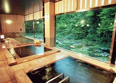 an indoor jacuzzi is shown in the middle of a room with large windows