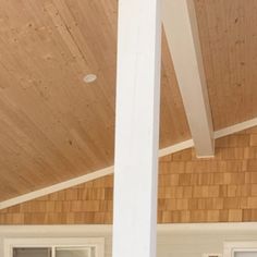 a cat sitting on top of a wooden porch