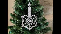 a christmas tree with a snowflake ornament on it