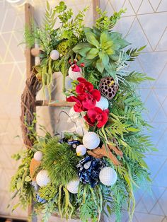 a ladder decorated with flowers and greenery