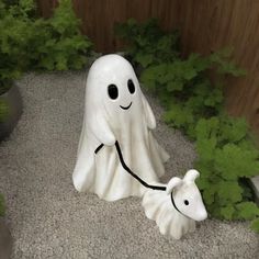 there is a ghost with a dog on the ground in front of some plants and bushes