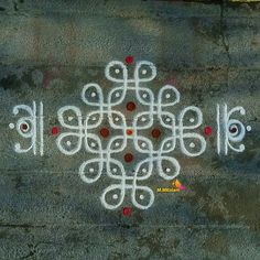 an artistic design is painted on the ground with white and red dots in the center