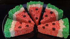 there is a cake made to look like watermelon slices on a black plate