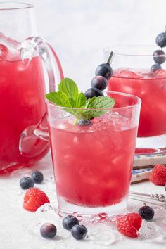 two glasses filled with watermelon, blueberries and mint garnishes