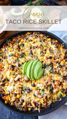 a skillet filled with taco rice and an avocado on the side