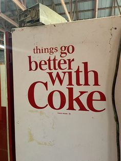 there is a sign that says things go better with coke