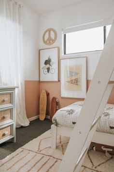 a bedroom with pink walls and white bedding has a wooden ladder in the corner