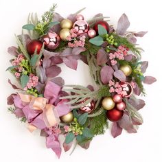 a christmas wreath with ornaments and greenery