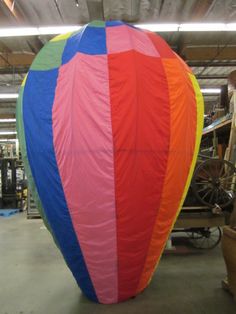 a large colorful hot air balloon in a warehouse