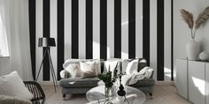 a living room with black and white striped walls