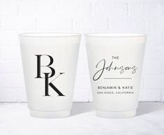 two white cups sitting next to each other