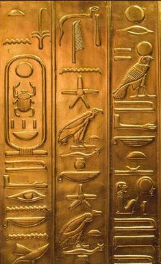 an egyptian gold hieroglyphic with symbols on it