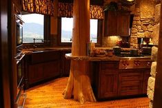 a kitchen with wooden cabinets and granite counter tops, along with an island in the middle