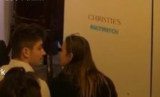 two people standing next to each other in front of a sign that says christie's smart tech