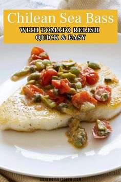 a white plate topped with fish and vegetables