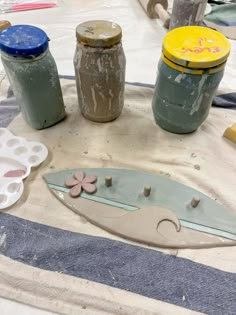 several jars and tools sitting on top of a table