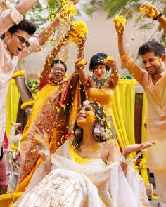 the bride and groom are throwing confetti on each other