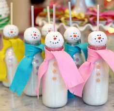 six snowmen with pink and blue scarfs on them