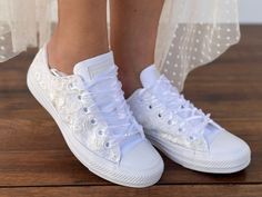 Consider these lacey sneakers like your favorite Converse, but personalized specifically for your wedding day. Forget traditional shoelaces; these white sneakers are tied with a romantic ribbon. (Choose from one of 20 different colored ribbons.) You can also personalize the heel with your initials and wedding date and add pearls to the toe cover. Or, keep it simple with the lovely lace speaking for itself. - Upper piece of durable canvas fabric - Classic toe cover made of cast rubber sole - All Shoes For Dancing, Lace Converse, Bride Converse, Custom Converse Shoes, How To Lace Converse, Bridal Converse, Converse Wedding Shoes, Custom Wedding Shoes, Bridal Sneakers