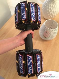 a person holding up some chocolate bars on top of a table