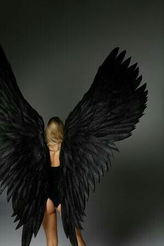 a woman with black wings on her body