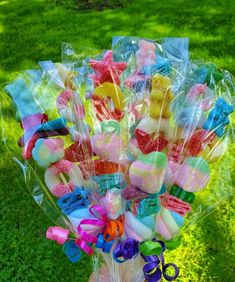 a bunch of lollipops in a vase on the grass