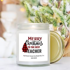 a glass jar filled with christmas candles on top of a table