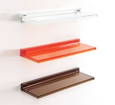 three glass shelves on the wall with one empty shelf and one closed shelf above them