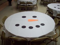 there is a snowman made out of white tablecloths with black dots on it