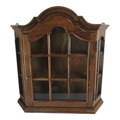 a wooden display case with glass doors on the front and bottom shelves, in an oak finish