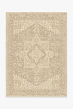 a beige rug with an intricate design on it