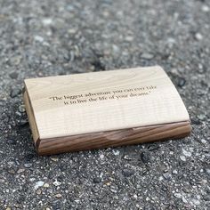 a wooden box sitting on the ground with a quote written on it that says, the biggest adventure you can take is to live the life of your dreams