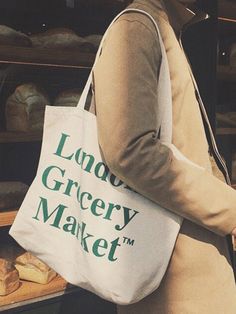 Editor's NotesThe tote bag is embroidered with the classic logo of the LONDON GROCERY MARKET.- Durable canvas material- Simple yet versatile- Inside pocket- Enough storageMeasurements (in.)One size- Width: 17.71 in.- Height: 13.77 in.- Strap: 23.62 in.Composition & Care- 100% Cotton- Hand wash only stained partDesigner- by LONDON GROCERY MARKET Daily Use Cotton Bag With Logo, Everyday Cotton Bag With Logo, Everyday Cotton Shoulder Bag With Logo, Everyday Cotton Bags With Logo, Cotton Shoulder Bag With Embroidered Logo For Shopping, Everyday Tote Shoulder Bag With Embroidered Logo, White Bags With Embroidered Logo For Shopping, Canvas Tote Bag With Embroidered Logo, White Canvas Bag With Logo