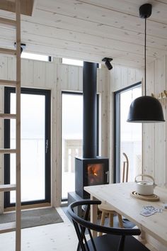 a dining room table with chairs and a fire place in the corner next to it