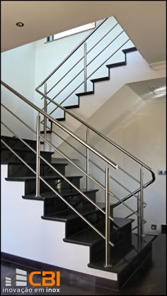 a set of stairs with glass railings and handrails in a modern home