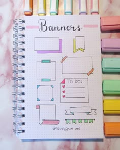 the planner is lined up with colored pencils on top of it and next to each other