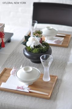 the table is set with white dishes and place settings