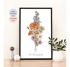 an art print with flowers on it sitting next to a vase and potted plant