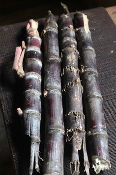 four stalks of bamboo sitting on top of a mat