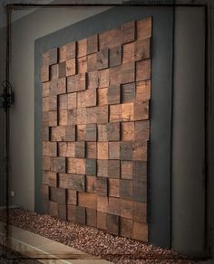 a wooden wall hanging on the side of a building