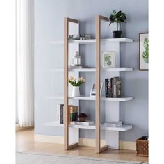 a white book shelf with books and plants on it in the corner of a room